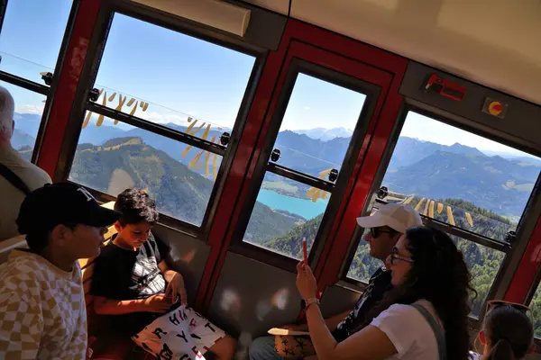 stock image SCHAFBERG, AUSTRIA - AUGUST 3, 2022: People ride the Schafbergbahn steam train to the top of mount Schafberg in Salzkammergut region of Austria. It is a metre gauge cog railway.