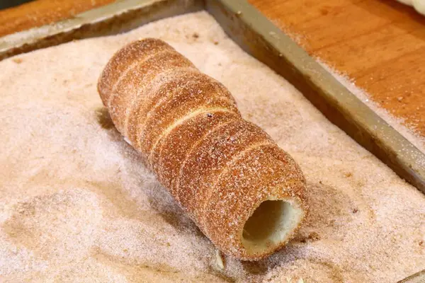 stock image Czech cuisine. Trdelnik chimney cake traditionally rolled in cinnamon and sugar.