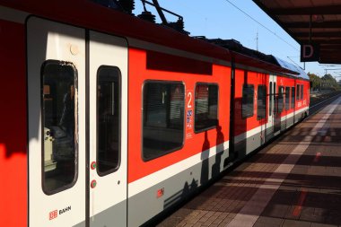 RECKLINGHAUSEN, GERMANY - SEPTEMBER 20, 2020: Deutsche Bahn passenger train at station platform in Recklinghausen. clipart