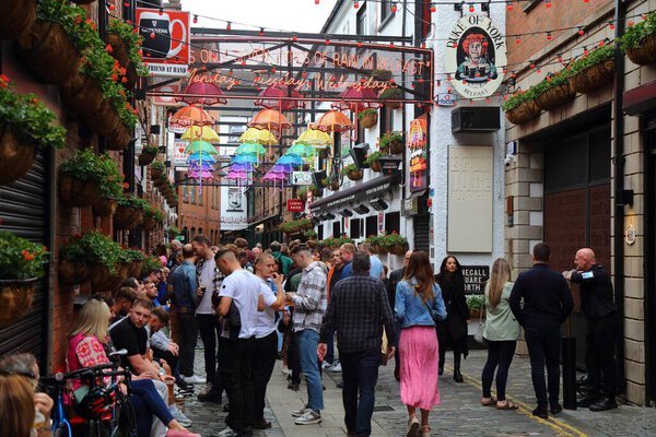 BELFAST, UK - JUNE 22, 2024: People visit Commercial Court in historic Cathedral Quarter in Belfast, Northern Ireland.