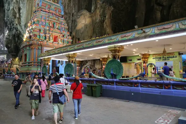 stock image BATU CAVES, MALAYSIA - MARCH 17, 2024: Pilgrims visit Batu Caves temple complex in the outskirts of Kuala Lumpur. Batu Caves is on of most recognized Hindu religion centres outside India.