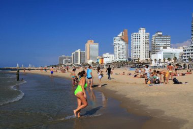 TEL AVIV, ISRAEL - NOVEMBER 2, 2022: People visit Allenby Beach (also known as Jerusalem Beach) in Tel Aviv, Israel. Tel Aviv is the economic and technological center of Israel.