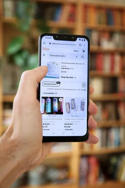 Stock image WARSAW, POLAND - JANUARY 29, 2021: User browsing personalized gifts Etsy marketplace on an Android OS, Xiaomi smart phone. Etsy is an online marketplace specializing in handicraft products.