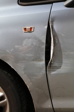 Generic car with scratched paint and dented parts on the side. Minor accident result - fender bender.