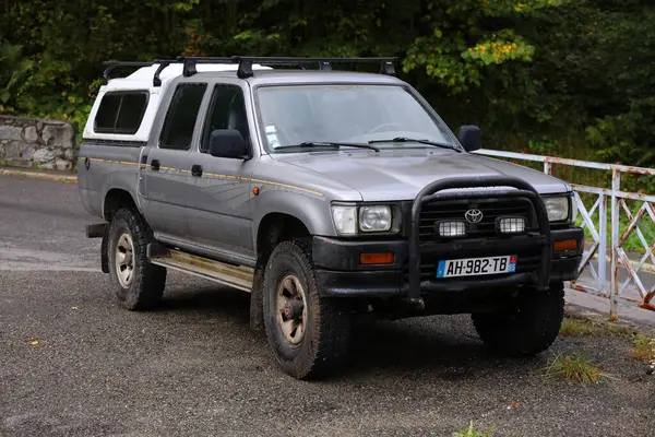 stock image BAREGES, FRANCE - SEPTEMBER 28, 2021: Toyota Hilux workhorse type of 4x4 vehicle parked in France.