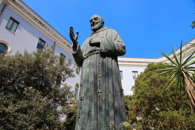 CATANIA, ITALY - AUGUST 7, 2024: Statue of saint Padre Pio of Pietrelcina in Catania city on Sicily island, Italy. clipart