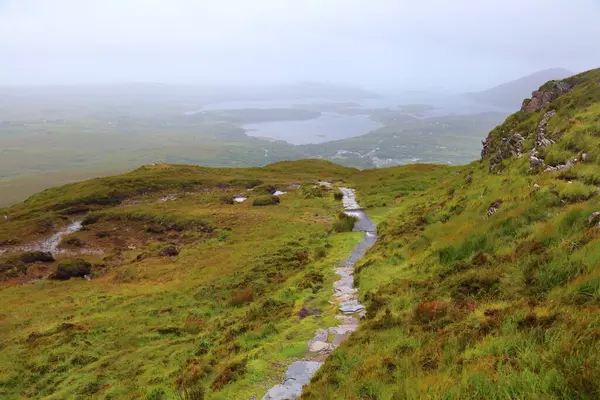 stock image Mountain hiking trail to Diamond Hill in Connemara National Park. Rainy weather in County Galway, Ireland.