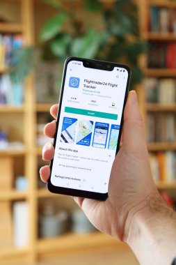 WARSAW, POLAND - JANUARY 29, 2021: User installing Flightradar24 flight tracking app on an Android OS, Xiaomi brand smart phone.