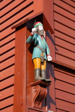 Bergen city in Norway. Wooden 18th century Viking sculpture in Bryggen quarter, UNESCO World Heritage Site. clipart