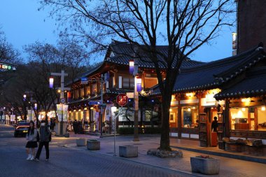 JEONJU, SOUTH KOREA - APRIL 3, 2023: Evening street view of Jeonju Hanok Village, traditional wooden architecture district in the city of Jeonju. clipart