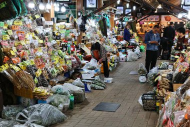 HWAGAE-MYEON, SOUTH KOREA - APRIL 3, 2023: People visit Hadong Hwagae Market in Hwagae. The market is known for Korean herbal medicine products from Jirisan Mountain area. clipart