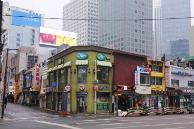 SEOUL, SOUTH KOREA - APRIL 6, 2023: Street view on a rainy day in downtown Jung-gu district in Seoul, South Korea. clipart