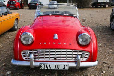 CADAQUES, SPAIN - OCTOBER 5, 2021: Vintage Triumph TR2 red roadster sports car parked in Spain. clipart