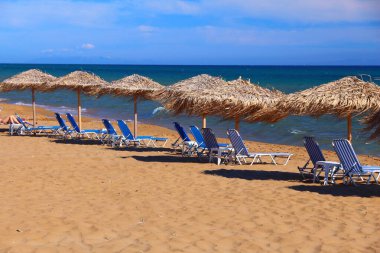 Gardenos Beach sunbeds in Corfu Island, Greece. Beach infrastructure on Greek island.