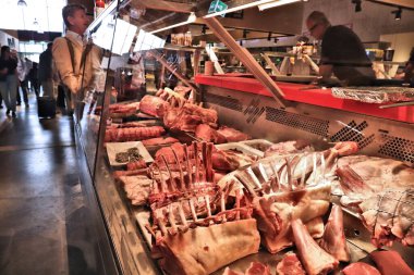 STOCKHOLM, SWEDEN - AUGUST 24, 2018: People visit butcher shop at Ostermalm's Market Hall (Ostermalms Saluhall) in Stockholm. It is a food marketplace focusing on meat, fish and gourmet food.