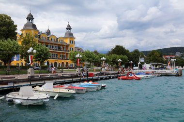 VELDEN AM WORTHER SEE, AUSTRIA - AUGUST 12, 2022: People visit lake Worthersee in Velden Am Worther See resort town in Carinthia, Austria.