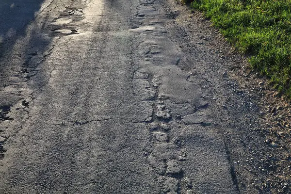 Avusturya, Carinthia 'da kırsal yol asfaltı hasar görmüş. Kırsal yol bakımı kavramı.