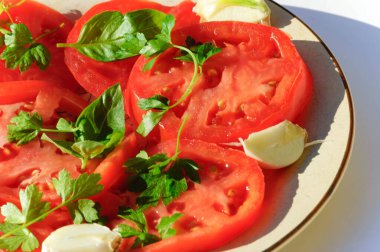close up of tomatoes slices, garlic, basilic and parsley