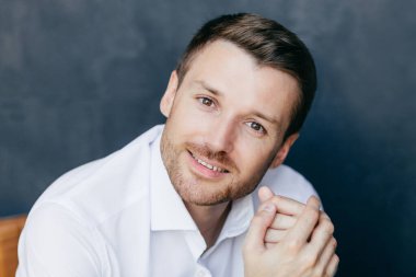 Çekici tıraşsız erkek ofis çalışanı işten sonra sonu vardır, sevinçle kameraya, iyi dinlenme olacak görünüyor, zarif beyaz gömlek giyer, yalnız kapalı teşkil etmektedir. İnsanlar, stil ve işgal kavramı