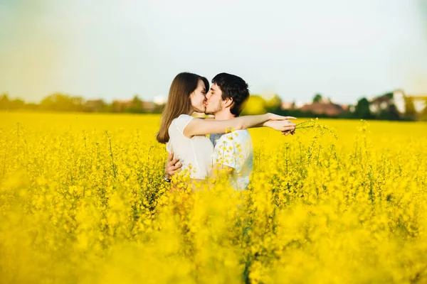 사랑하는 남녀는 껴안고 꽃들을 대하면서 키스를 관계와 헌신을 나타낸다 사람들 — 스톡 사진