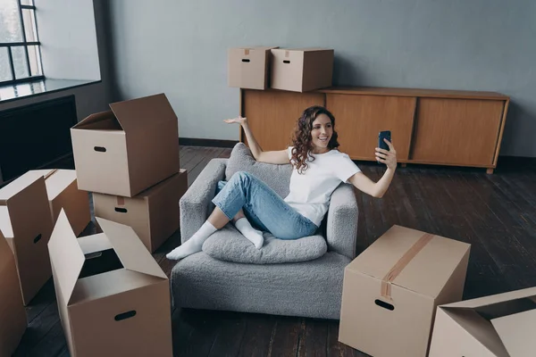 Happy Spanish Girl Sitting Armchair Having Video Call Smartphone Owner — Stok fotoğraf
