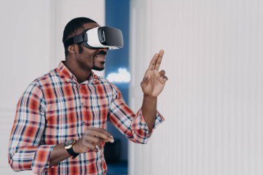 African american guy wearing virtual reality glasses, enjoying leisure free time in cyberspace. Modern black man playing video game simulation, testing purchase in online store. E commerce, tech