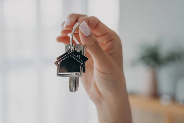 stock image Key to new house. Close-up of female hand hold bunch of keys. Woman real estate agent realtor makes offer, showing key from new home apartment. Purchase of housing, copy space.