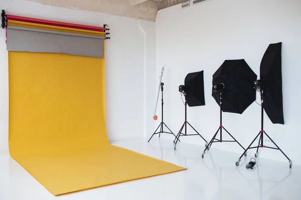 stock image Shot of studio with modern interior annd lightning equipment. Photo of up do date photo studio prepared for photosession. Room lighted with spotlights.