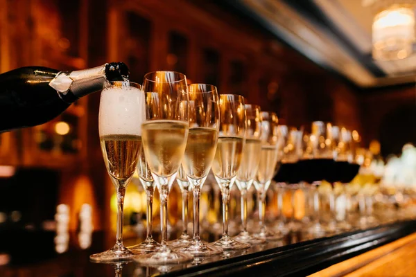 Row Glasses Filled Champagne Other Beverages Someone Holds Bottle Fills — Stock Photo, Image