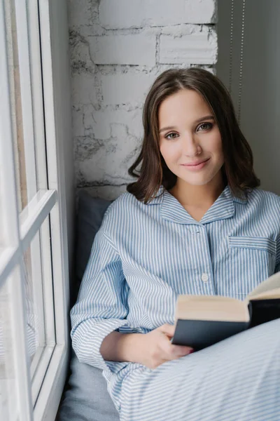 Young Woman Casual Clothes Reading Romantic Book Window Enjoying Coziness —  Fotos de Stock
