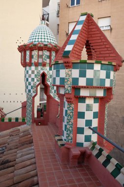 Casa Vicens in Gracia, Barcelona, Spain - October 2023: This stunning architectural marvel showcases Gaudi's unique style with vibrant colors and intricate tile work adorning its rooftop. clipart