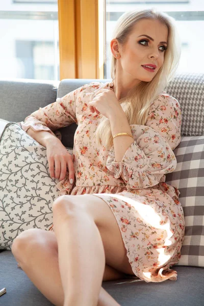 Attractive Beautiful Young Blonde Girl Sitting Sofa Floral Dress Bright — Stock Photo, Image