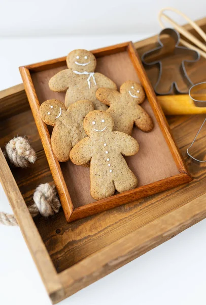 Gingerbread Man. Cooking gingerbread cookies at home lies on a wooden tray. The concept of the holiday of Christmas and New Year