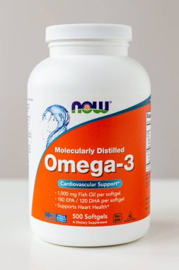 Kyiv, Ukraine - 27 January 2022: Now Foods Omega-3 natural fish oil concentrate - purified at the molecular level. Jar with of omega capsules for cardiovascular support from Natural Organic Wholesome