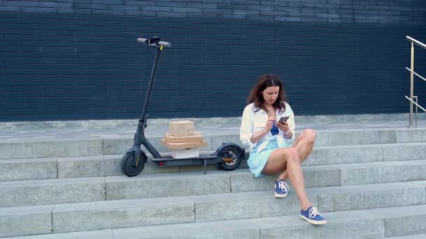 Girl Skirt Phone Her Hands Sits Steps Electric Scooter Folded — Stockvideo
