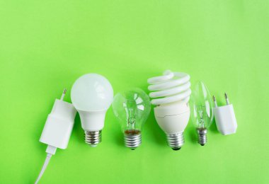 A set of different types of LED lamps isolated on a green background. Energy-saving lamps