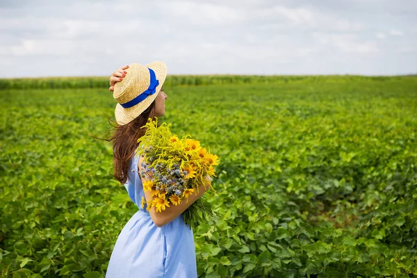 Güzel Kız Elinde Bir Buket Sarı Çiçek Hasır Şapkayla Tarlada — Stok fotoğraf