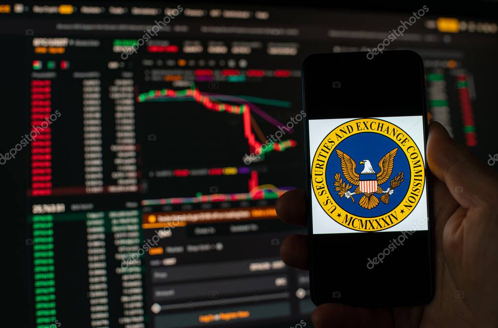 Kyiv, Ukraine - 06 June 2023: Man holds a smartphone with SEC logo against the background falling Bitcoin chart on Binance - crash. S.E.C. Accuses Binance of Mishandling Funds and Lying to Regulators
