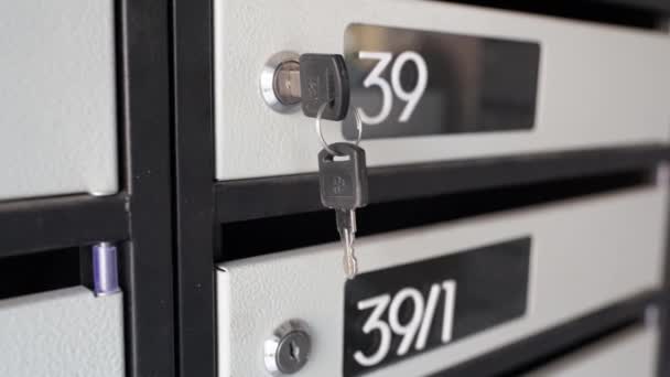 公寓大楼里的钢制信箱里有两把摇摆不定的钥匙信件 收据和杂项信件的编号信箱 公寓里有私人信箱的钥匙 — 图库视频影像