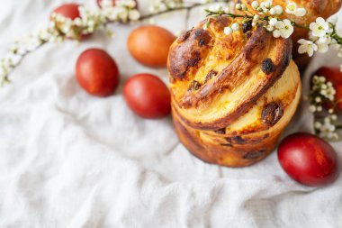 Geleneksel Paskalya ekmeği. Boyalı yumurtalar ve desenli kumaş üzerinde çiçekler. Şenlikli, renkli ve iştah açıcı.