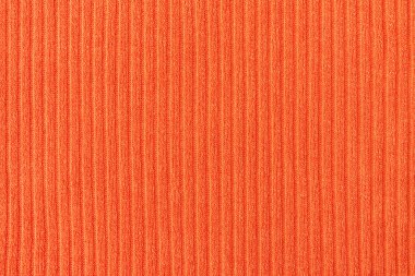 Dikey çizgileri olan turuncu kumaş yakın plan. Yumuşak, sıcak ve zarif tekstil arkaplanı