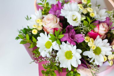 Güller, papatyalar ve alstroemeryalar da dahil olmak üzere pastel renkte güzel bir buket taze çiçek sepeti..