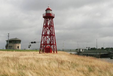 Netherlands,Afsluitdijk, july 2016:An old lighthouse near the locks clipart