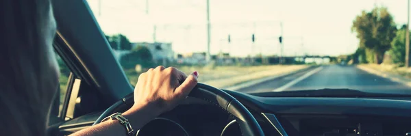 Stock image Woman driving a car, view on the street from inside of vehicle, panoramic shot