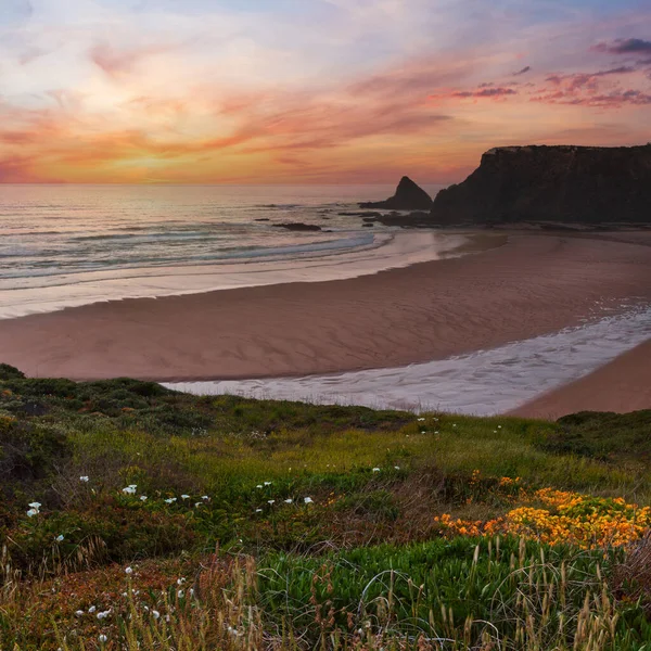 Pink sunset ocean scenery and summer Odeceixe beach (Aljezur, Algarve, Portugal).