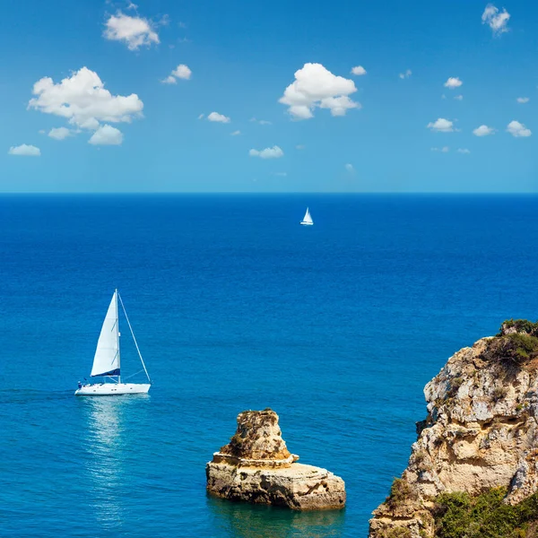 Two sailing boats in sea. Top view from shore (Ponta da Piedade, Algarve, Portugal).
