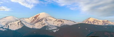 Sunrise landscape in spring Carpathian mountains, Ukraine, Europe. High-resolution extra wide panorama multi shots stitch image of Chornohora ridge from Pozhezhevska to Hoverla and Petros mountains.