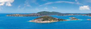 Beautiful summer Aegean Sea coast landscape (near Lagonisi , Sithonia, Halkidiki, Greece). People are unrecognizable.