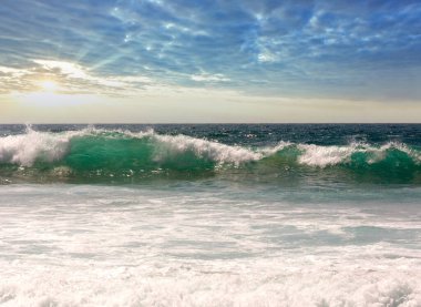 Deniz fırtınası dalgaları. Sahilden gün batımı manzarası.