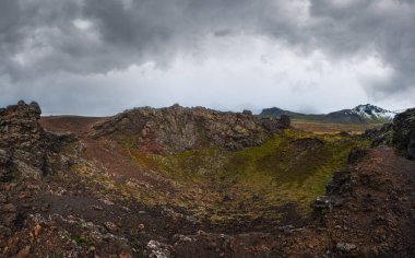 Spectacular volcanic view from Saxholl Crater, Snaefellsnes peninsula, West Iceland. Snaefellsjokull snowy volcano top in far.